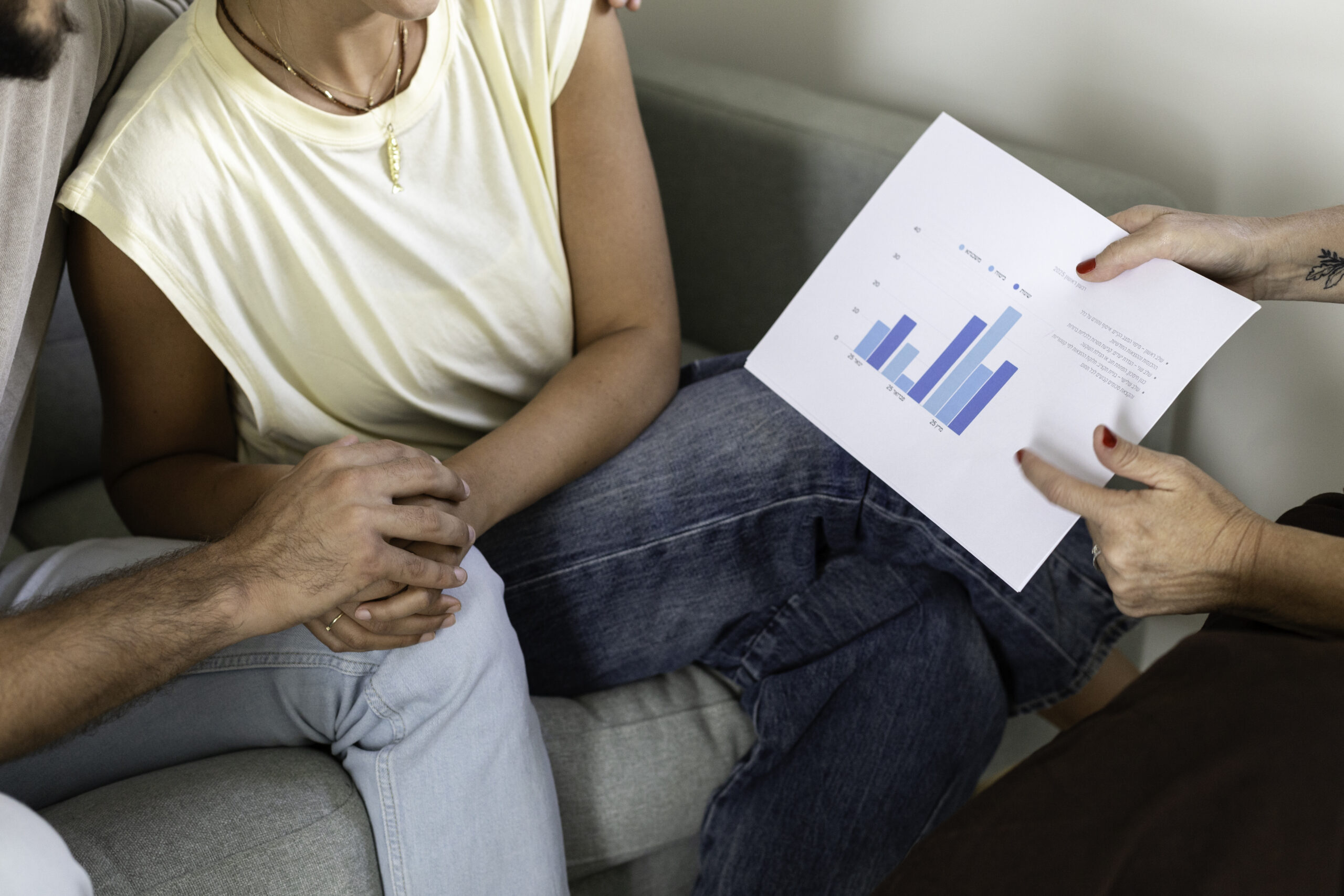 זוג מחזיק ידיים אל מטל טבלה כלכלית